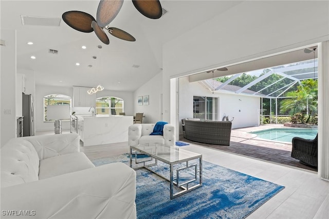 2050 Terrazzo Ln, Naples, FL 34104 - living area with a sunroom, lofted ceiling, a ceiling fan, and recessed lighting