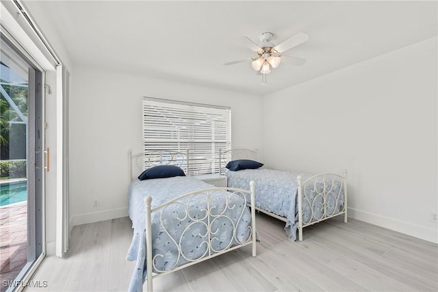 2050 Terrazzo Ln, Naples, FL 34104 - bedroom featuring access to exterior, multiple windows, wood finished floors, and a ceiling fan