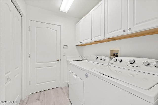 2050 Terrazzo Ln, Naples, FL 34104 - laundry area featuring cabinet space, washer and dryer, and light wood-style flooring