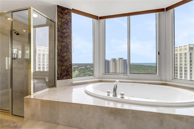 7117 Pelican Bay Blvd Unit 1801, Naples, FL 34108 - full bathroom featuring a stall shower, a garden tub, and wallpapered walls
