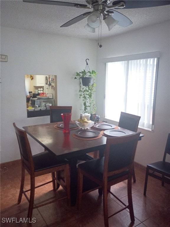 340 Easton Ct, Lehigh Acres, FL 33936 - dining room with a ceiling fan, tile patterned floors, and a textured ceiling