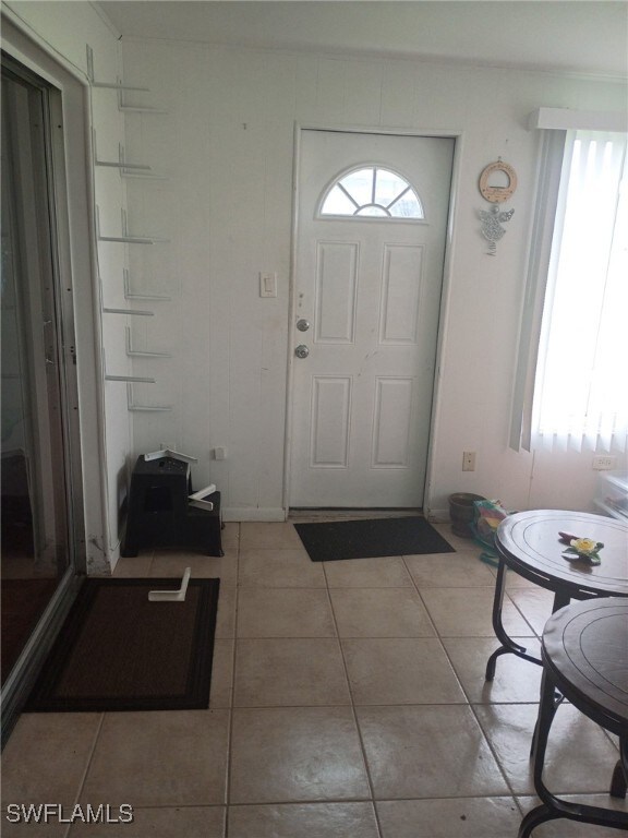 340 Easton Ct, Lehigh Acres, FL 33936 - entryway featuring plenty of natural light and light tile patterned floors