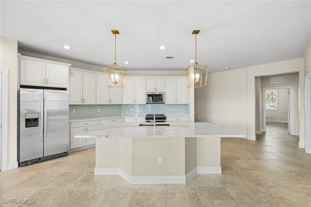 15140 Palmer Lake Cir Unit 201, Naples, FL 34109 - kitchen featuring appliances with stainless steel finishes, tasteful backsplash, a kitchen island with sink, hanging light fixtures, and recessed lighting