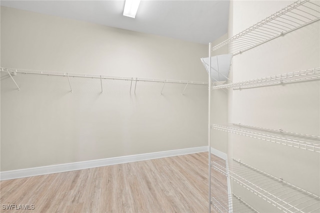 15140 Palmer Lake Cir Unit 201, Naples, FL 34109 - spacious closet featuring wood finished floors