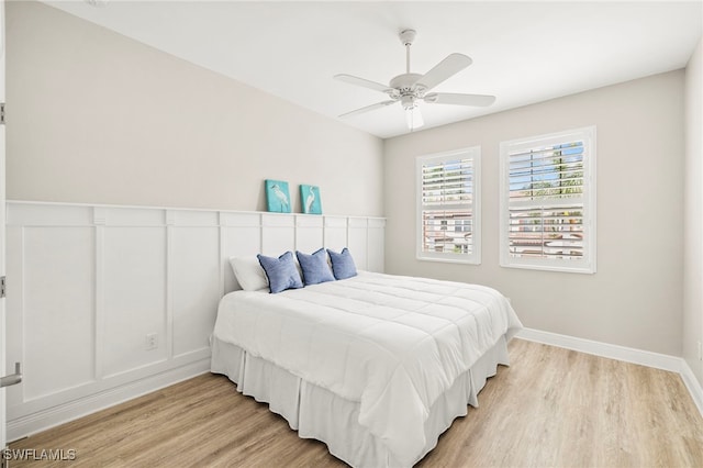 15140 Palmer Lake Cir Unit 201, Naples, FL 34109 - bedroom featuring light wood-type flooring and ceiling fan