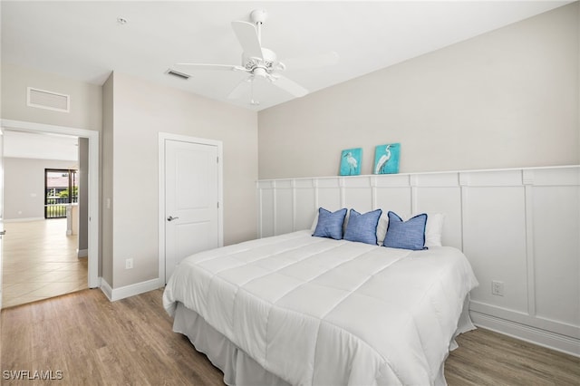 15140 Palmer Lake Cir Unit 201, Naples, FL 34109 - bedroom featuring wood finished floors and a ceiling fan