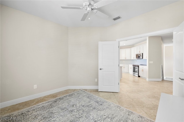15140 Palmer Lake Cir Unit 201, Naples, FL 34109 - unfurnished room featuring a ceiling fan and light tile patterned floors
