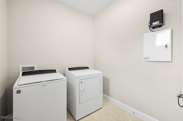 15140 Palmer Lake Cir Unit 201, Naples, FL 34109 - laundry area with washer and clothes dryer and baseboards