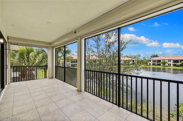 15140 Palmer Lake Cir Unit 201, Naples, FL 34109 - unfurnished sunroom with a water view