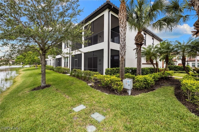 15140 Palmer Lake Cir Unit 201, Naples, FL 34109 - rear view of house with stucco siding and a lawn