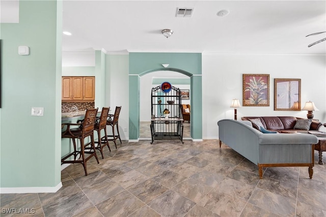 8014 Kilkenny Ct Unit G47, Naples, FL 34112 - living area featuring ornamental molding, arched walkways, and stone finish floors