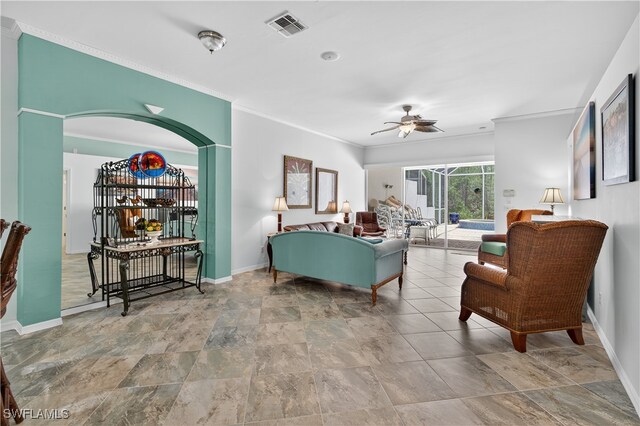 8014 Kilkenny Ct Unit G47, Naples, FL 34112 - living room with ornamental molding, ceiling fan, stone finish flooring, and arched walkways