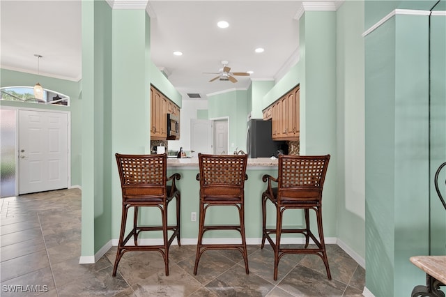 8014 Kilkenny Ct Unit G47, Naples, FL 34112 - kitchen with crown molding, stainless steel appliances, ceiling fan, light countertops, and a peninsula