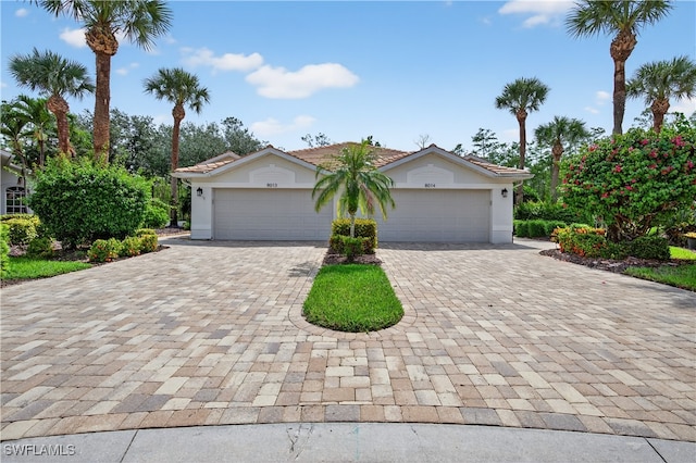 8014 Kilkenny Ct Unit G47, Naples, FL 34112 - view of front of house featuring decorative driveway, stucco siding, and a garage