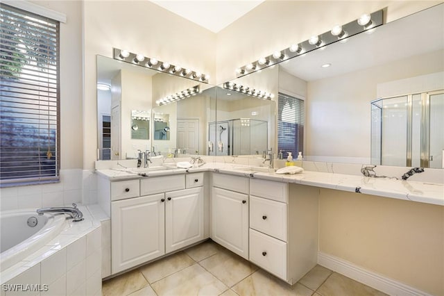4780 Shinnecock Hills Ct Unit 102, Naples, FL 34112 - bathroom featuring a stall shower, a garden tub, tile patterned flooring, and double vanity