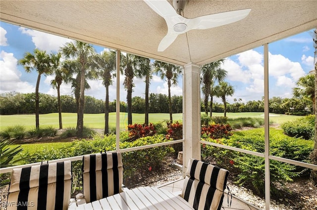 4780 Shinnecock Hills Ct Unit 102, Naples, FL 34112 - unfurnished sunroom with view of golf course, a ceiling fan, and view of wooded area