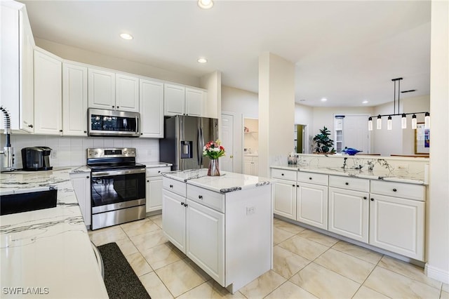 4780 Shinnecock Hills Ct Unit 102, Naples, FL 34112 - kitchen with appliances with stainless steel finishes, tasteful backsplash, white cabinetry, light stone counters, and recessed lighting