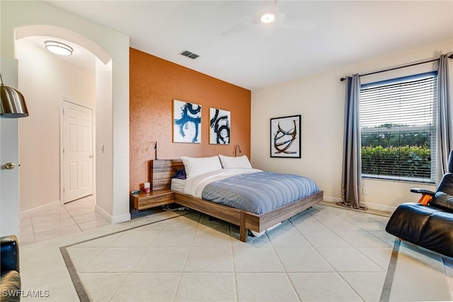 4780 Shinnecock Hills Ct Unit 102, Naples, FL 34112 - bedroom featuring arched walkways, an accent wall, and light tile patterned floors