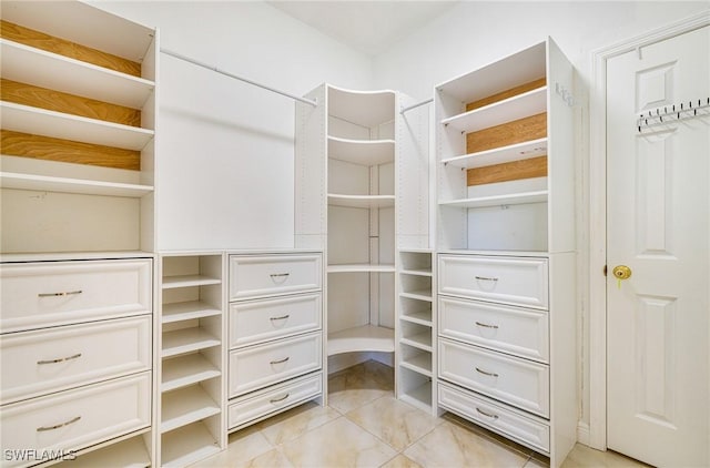 4780 Shinnecock Hills Ct Unit 102, Naples, FL 34112 - walk in closet featuring light tile patterned floors