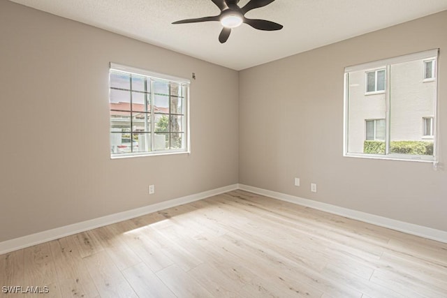 7718 Jewel Ln Unit 101, Naples, FL 34109 - spare room with healthy amount of natural light, a ceiling fan, and light wood-style floors