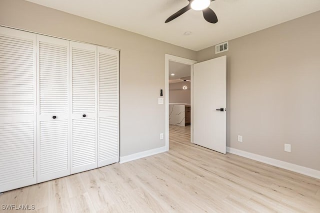 7718 Jewel Ln Unit 101, Naples, FL 34109 - unfurnished bedroom with a closet, light wood finished floors, and a ceiling fan