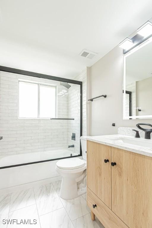7718 Jewel Ln Unit 101, Naples, FL 34109 - bathroom featuring vanity, bath / shower combo with glass door, and marble finish floors