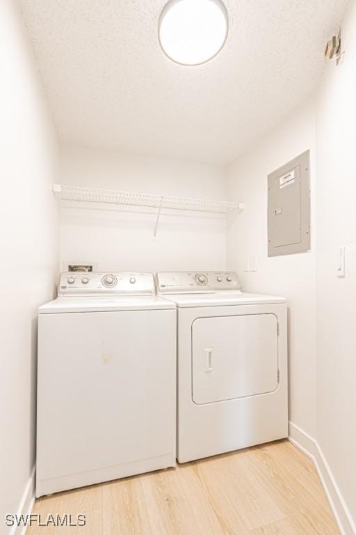 7718 Jewel Ln Unit 101, Naples, FL 34109 - washroom with electric panel, washer and dryer, and light wood-type flooring
