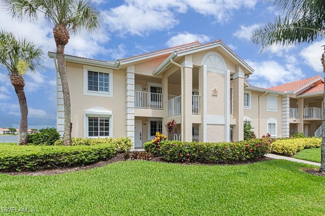 7718 Jewel Ln Unit 101, Naples, FL 34109 - view of front of property with stucco siding and a front yard