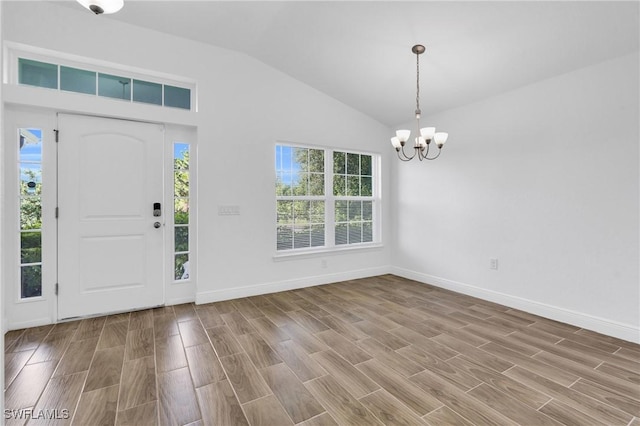 2920 6th St SW, Lehigh Acres, FL 33976 - foyer entrance featuring a chandelier, lofted ceiling, and wood finished floors