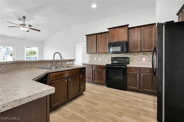 2920 6th St SW, Lehigh Acres, FL 33976 - kitchen featuring black appliances, vaulted ceiling, ceiling fan, tasteful backsplash, and light countertops