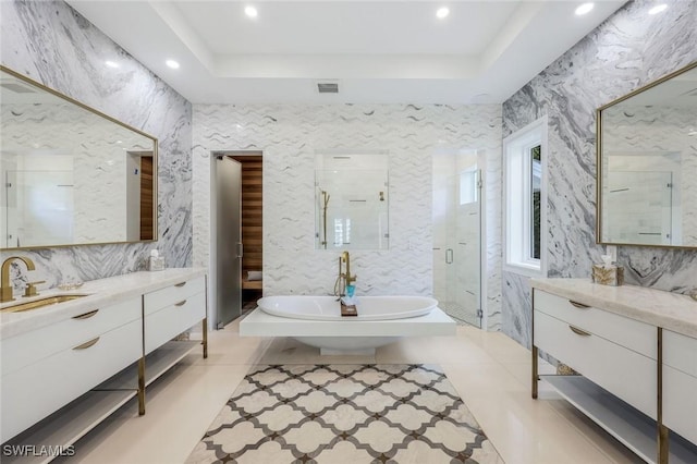 309 Neapolitan Way, Naples, FL 34103 - full bath featuring a raised ceiling, a freestanding tub, vanity, a shower stall, and recessed lighting