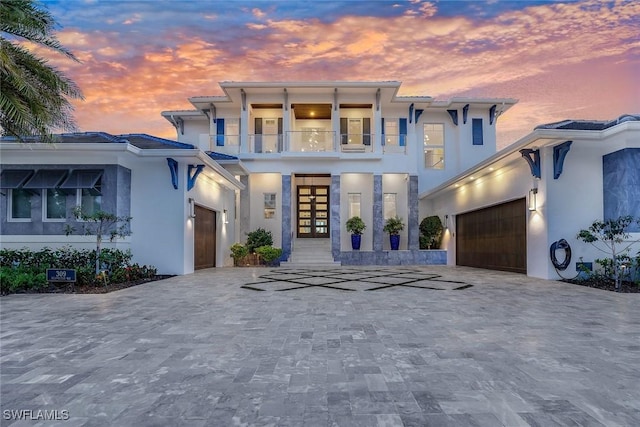 309 Neapolitan Way, Naples, FL 34103 - view of front of home with a balcony, a garage, french doors, and decorative driveway