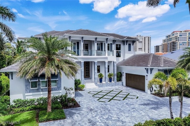 309 Neapolitan Way, Naples, FL 34103 - view of front facade with a balcony, stucco siding, a garage, and a tiled roof