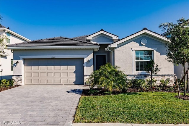 2667 Scarlet Way, Naples, FL 34120 - single story home featuring stucco siding, decorative driveway, a garage, and a front lawn
