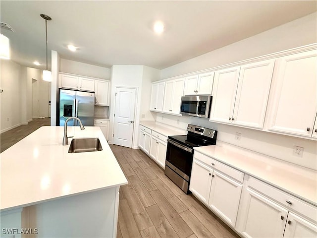 2667 Scarlet Way, Naples, FL 34120 - kitchen featuring stainless steel appliances, light wood finished floors, white cabinets, light countertops, and recessed lighting