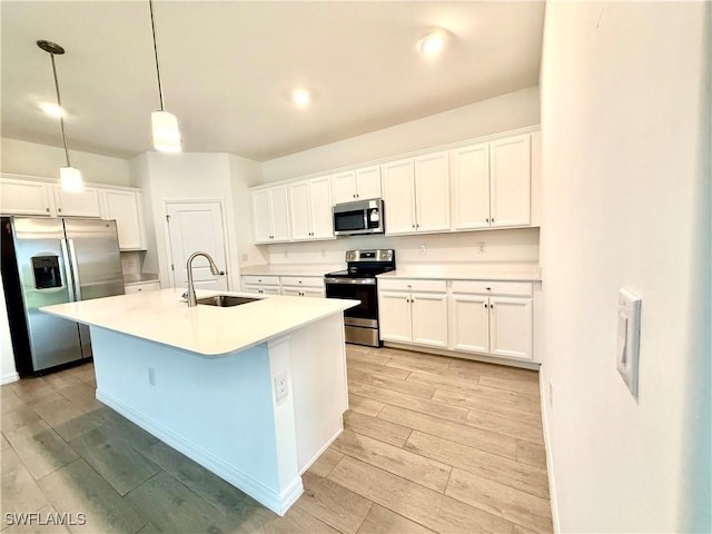 2667 Scarlet Way, Naples, FL 34120 - kitchen featuring appliances with stainless steel finishes, light wood-type flooring, white cabinets, and light countertops