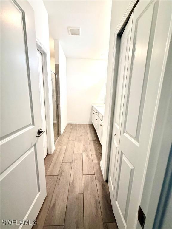2667 Scarlet Way, Naples, FL 34120 - corridor with light wood-type flooring and baseboards