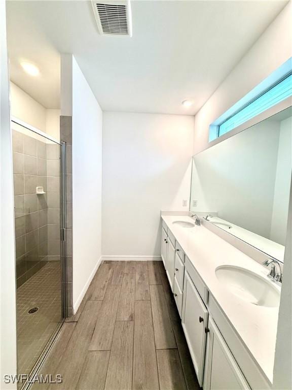 2667 Scarlet Way, Naples, FL 34120 - full bathroom featuring wood finished floors, a shower stall, double vanity, and recessed lighting