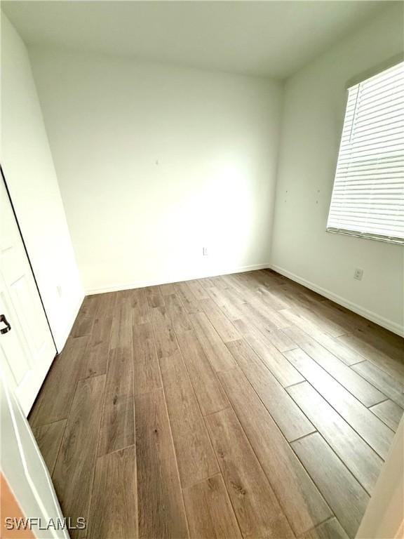 2667 Scarlet Way, Naples, FL 34120 - unfurnished room with wood finished floors and baseboards