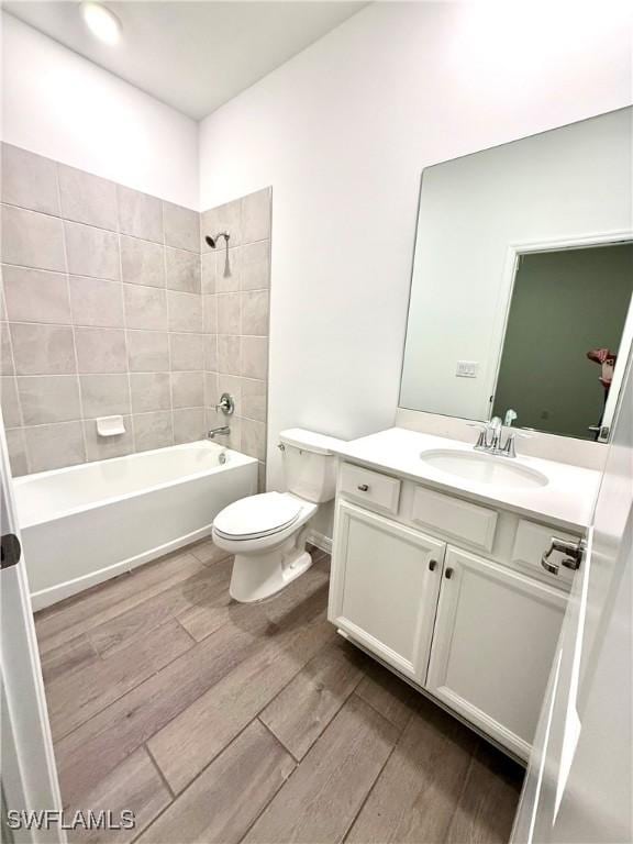 2667 Scarlet Way, Naples, FL 34120 - bathroom featuring wood finished floors, vanity, and washtub / shower combination
