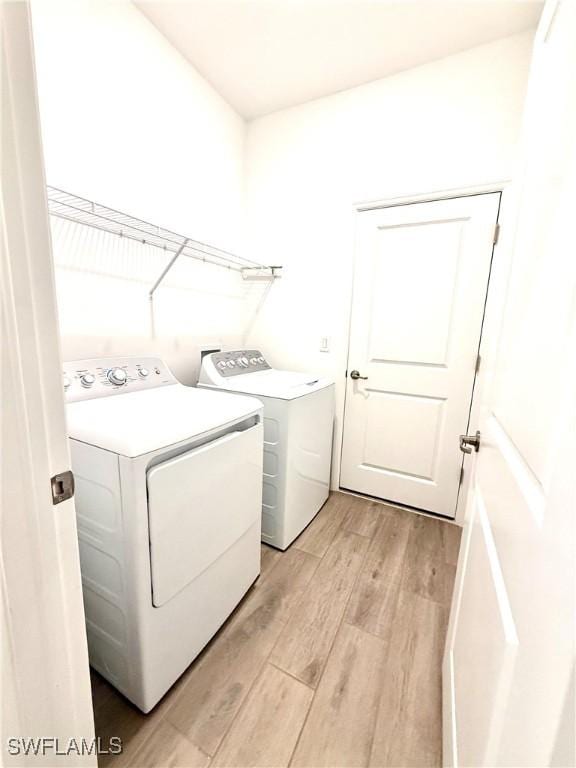 2667 Scarlet Way, Naples, FL 34120 - laundry area with washer and dryer and light wood finished floors