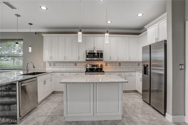 4582 Fairloop Run, Lehigh Acres, FL 33973 - kitchen with stainless steel appliances, a peninsula, white cabinets, tasteful backsplash, and ornamental molding
