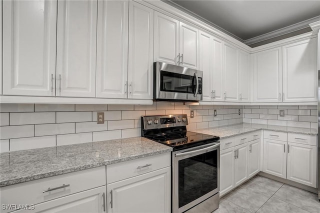 4582 Fairloop Run, Lehigh Acres, FL 33973 - kitchen with appliances with stainless steel finishes, white cabinets, tasteful backsplash, light stone countertops, and ornamental molding