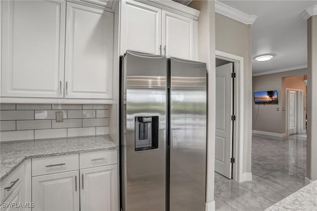 4582 Fairloop Run, Lehigh Acres, FL 33973 - kitchen with stainless steel fridge with ice dispenser, crown molding, backsplash, white cabinets, and light stone countertops