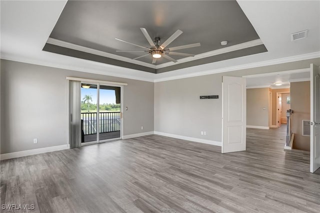 4582 Fairloop Run, Lehigh Acres, FL 33973 - unfurnished room with a tray ceiling, a ceiling fan, wood finished floors, crown molding, and a smoke detector