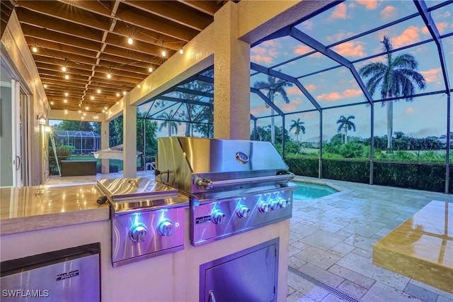 4582 Fairloop Run, Lehigh Acres, FL 33973 - patio terrace at dusk featuring area for grilling, a patio, and glass enclosure