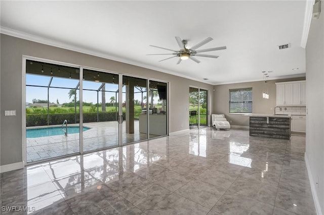 4582 Fairloop Run, Lehigh Acres, FL 33973 - unfurnished living room with plenty of natural light, ornamental molding, light marble finish floors, and ceiling fan