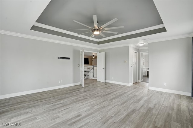 4582 Fairloop Run, Lehigh Acres, FL 33973 - unfurnished living room with a tray ceiling, ceiling fan, light wood-type flooring, and ornamental molding