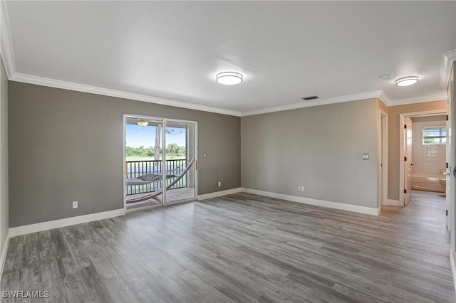 4582 Fairloop Run, Lehigh Acres, FL 33973 - spare room featuring wood finished floors and ornamental molding
