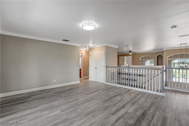 4582 Fairloop Run, Lehigh Acres, FL 33973 - spare room featuring wood finished floors, ornamental molding, and ceiling fan